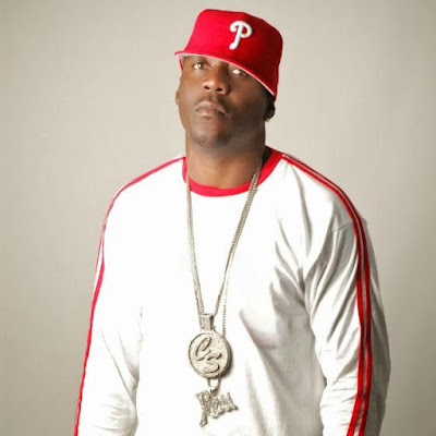 @PapaReu in a white/red long sleeve shirt with a red Philly's hat and two chains.