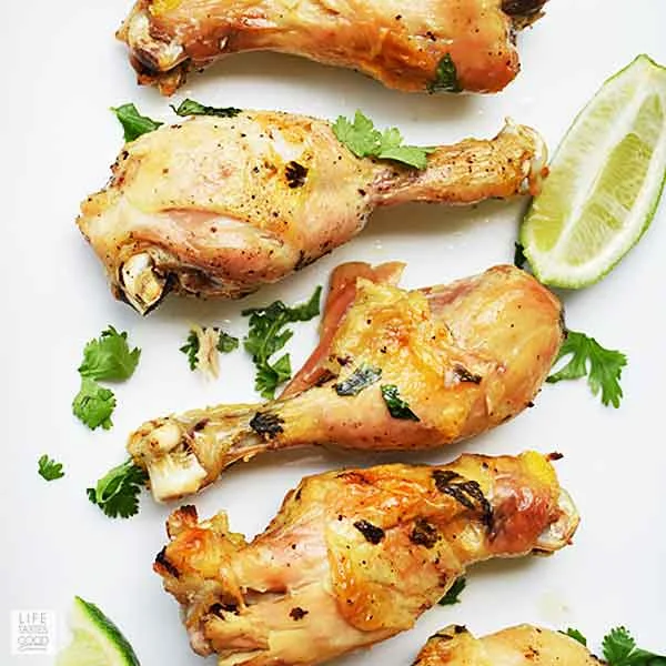 Slow Cooker Cilantro Lime Chicken Drumsticks on a white serving tray - top view looking down