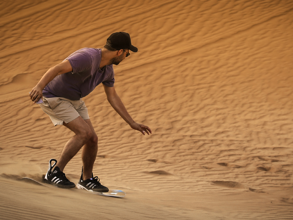 Man sand boarding in Dubai Deserts