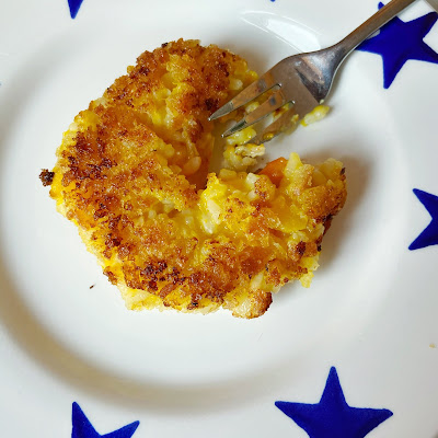 Homemade arancini (leftover risotto) on a plate with a fork