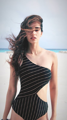 Disha Patani at beach in black with white stripe swimsuit unravelling her beach ready body