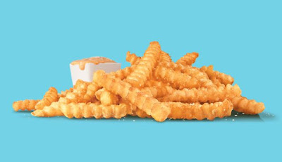 Sonic's new Groovy Fries with a cup of Groovy Sauce.