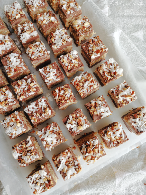 Easy German Chocolate Fudge! A simple, fool-proof recipe for chocolate fudge layered with pecan coconut German chocolate filling made easy with sweetened condensed milk.