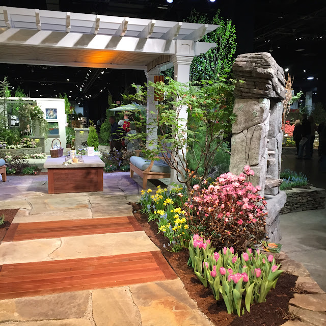 I love the way they combined wood planks and stone together in this beautiful garden walkway | Boston Flower & Garden Show 2017