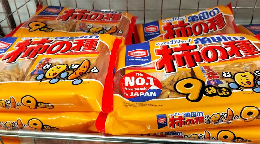 Packs of Kameda Kaki no tane rice crackers at a Japanese supermarket.