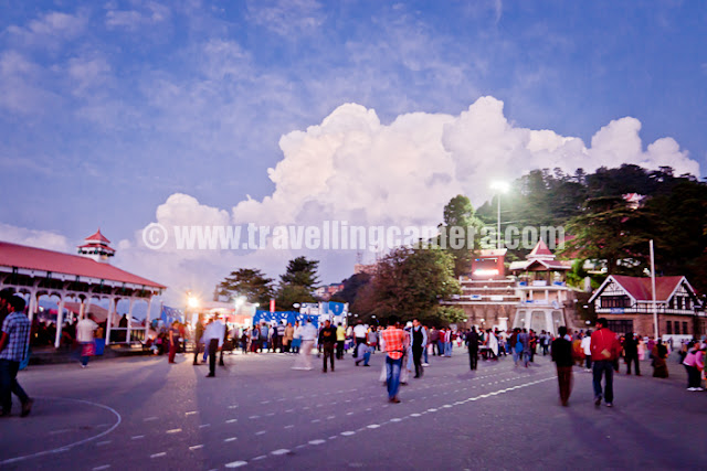 During recent trip to Shimla, I was travelling on bikes most of the time. Our bikes even hit the restricted regions like Mall Road, Ridge and Lakkar bazar... Let's have a quick Photo Journey of Shimla !!!New look of Gaiety Theatre in Shimla. This Theatre is situated on Mall Road and now open for all. There is small ticket amount one needs to pay to explore it inside. Various plays, exhibitions and other cultural events take place at Gaiety Theatre. Some part of Gaiety is also visible from Ridge.Afternoon view of Ridge, Shimla !!! Some Himachal Tourism activity was going and Aneesh was allowed to take his bike to Ridge with proper care. Ridge, Mall Road and Lakkar Bazar regions are restricted areas where vehicles are not allowed.Birds roaming around Ridge/Mall Road during Saturday Evening :) ... Saturday evenings are very popular for folks in Shimla and Mall road is too much crowded during Saturday evenings. Bird watching could be one of the reasons..A view of Shimla from High Court building. This photograph is clicked from Mall Road only, but near High Court of Himachal Pradesh !!!I am completely in love with Shimla Architecture and my camera couldn't resist clicking all those building on Shimla streets & roads. This photograph was clicked while we were climbing up towards Mall Road from HHH hotel.More beautiful buildings from Shimla, but increasing vehicles are becoming one of the main challenges when parking is biggest issue in the city. But it's amazing to these folks driving so fast on narrow roads with lots of curves here and thereHere comes Mr. Aneesh Awasthi. Here he is trying typical short cuts in Shimla, but mostly they are for walking people not for bikers. Since it's difficult for Aneesh to walk, so he thought of riding down these stairs.During noon there is nothing on Mall road so came down towards Shimla Market and thought of going towards Naldera Golf ground... Although plans changed later. I hope you noticed the density of houses on these hills. There is no difference between these hill stations and metros like Delhi now.Here is a view of Mall road after sunset. Folks have started coming to Mall Road and soon it will be fully loaded, or in fact overloaded.Here is another view of Ridge in Shimla. Ridge and Mall road are well connected with each other and have many decent restuarants around the place. Ridge is basically a huge tank of water which is main supply for various parts of Shimla. There is also an underground makrket called Indira Market and Press Club of Shimla is also situated in this market.Wonderful view of Christ Church on Ridge, Shimla. Bright blue sky make this photograph more intersting... This was a qick photo journey with no plans and thought of sharing here... Hope to be there in Shimla for Christmas and wish to click some the same places with snow !!!