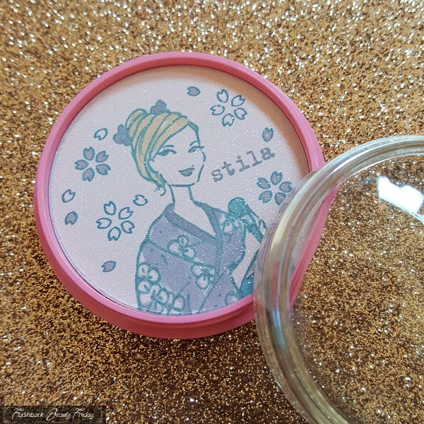 retro face powder with kimono clad girl with powder brush illustration on surface and sparkles