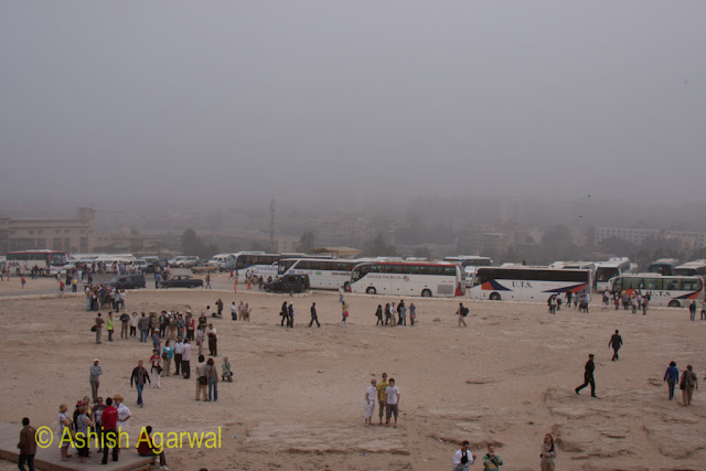 Cairo Pyramid - View of tourists, their buses, and Giza, in the background