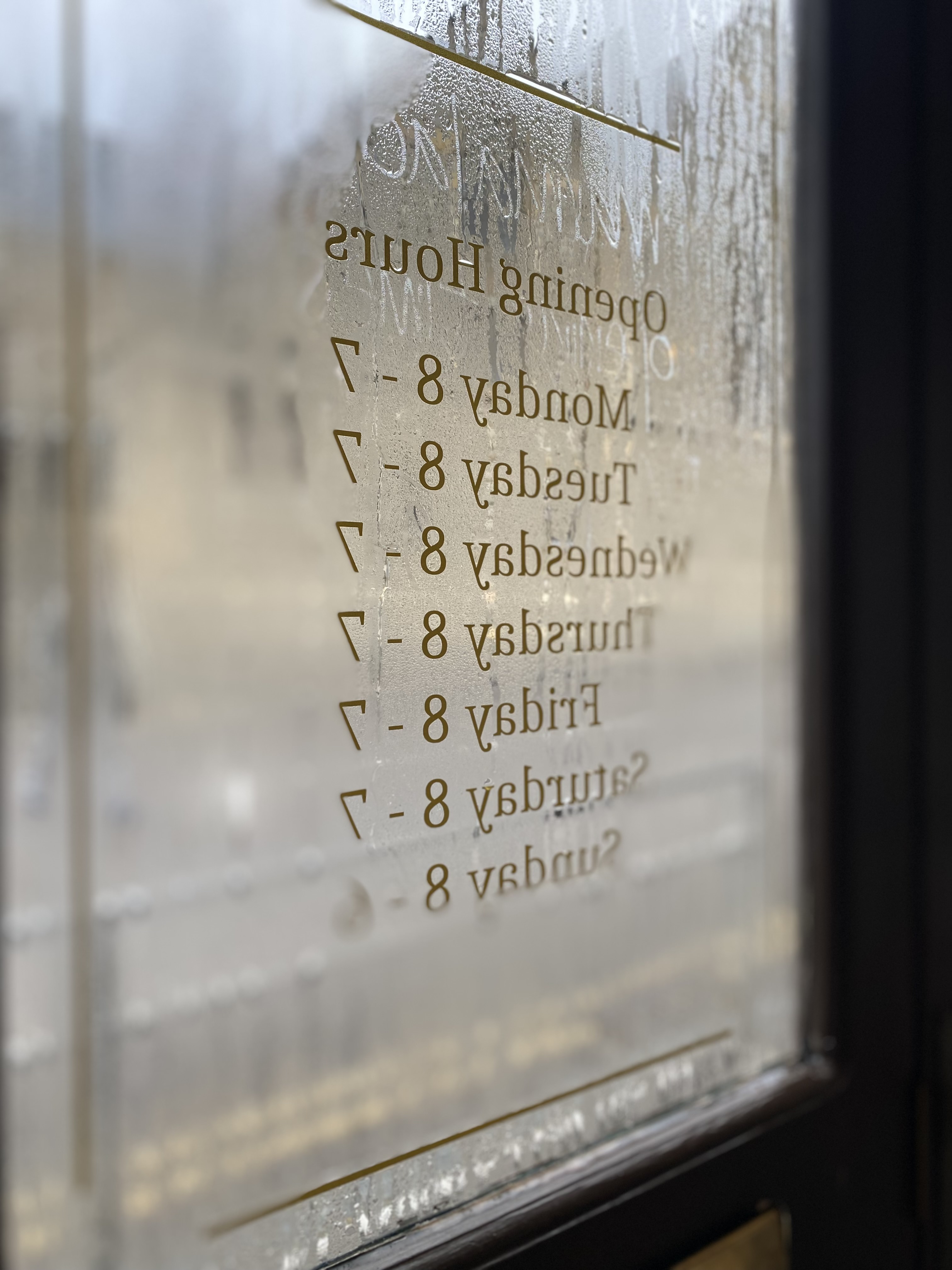 Inside of glass door with opening hours on it, Marmalade Kemptown