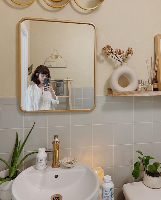 white modern donut vase on display in neutral bathroom