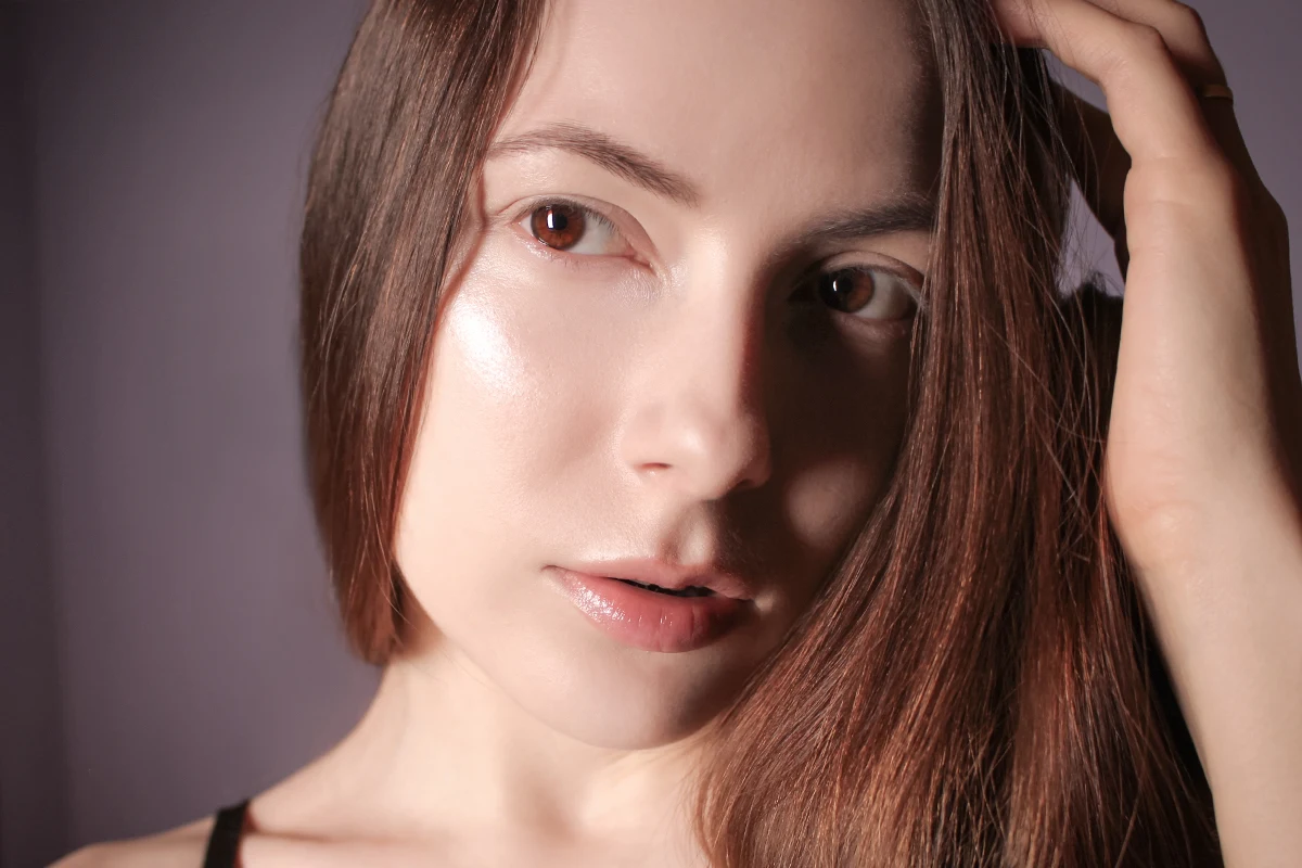 close-up of woman's face with no makeup and glowing skin