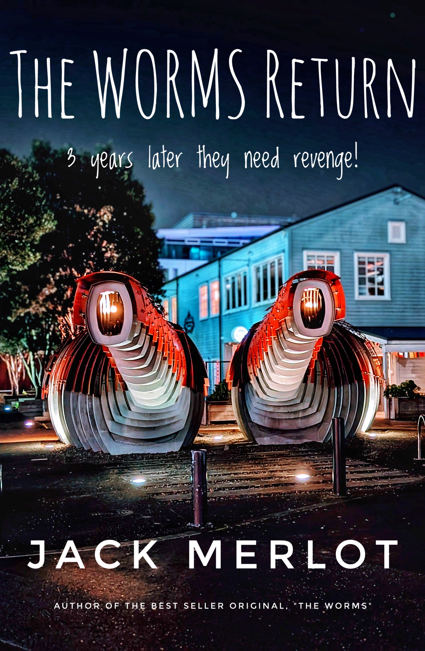 Imagined book cover, "The Worms Return", an edited night photo of the two stylised public toilets near the Wellington waterfront. Each with a rippled body (the toilet) with a protuberance that resemble the toothed mouth of a worm monster.