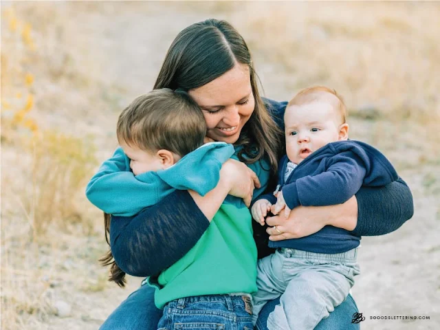 mom holding two kids