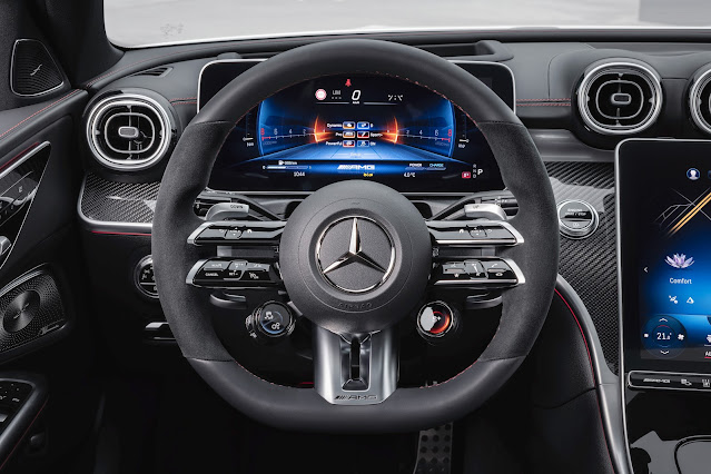 2023 Mercedes-AMG C 43 Sedan - the two-round AMG steering wheel buttons allow fast switching of various dynamic driving functions and AMG DYNAMIC SELECT drive programs.