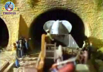 Henry train engine cargo truck wagon and a large cross gray elephant came out old stone tunnel exit