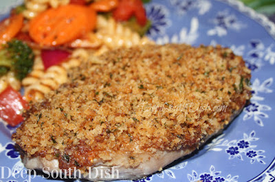 Boneless pork chops, topped with a sweet and tangy mustard layer, finished with crispy, browned panko breadcrumbs, then baked low and slow, makes for a tender and juicy chop, shown here with my Supreme Pasta Salad.