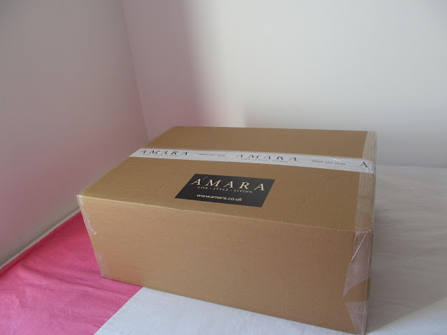 large brown package with black Amara label