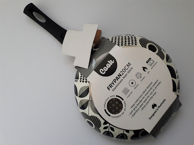 Small non-stick frying pan with a graphic mod daisy print on the outside