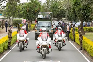 President UK on the presidential van greeting people.