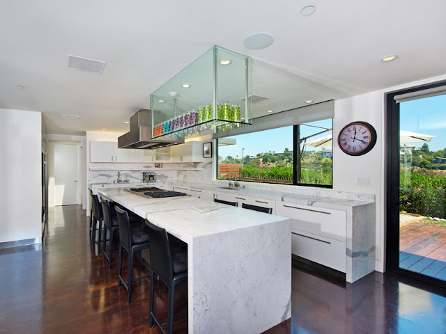 Photo of large kitchen with huge kitchen island in the middle