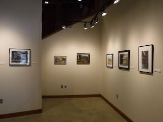 mounted and framed 8x10 photos from the Sioux City Camera Club are lined up at eye height in the main gallery at the Betty Strong Encounter Center