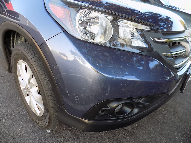 Close-up of bumper scrapes before repairs at Almost Everything Auto Body.