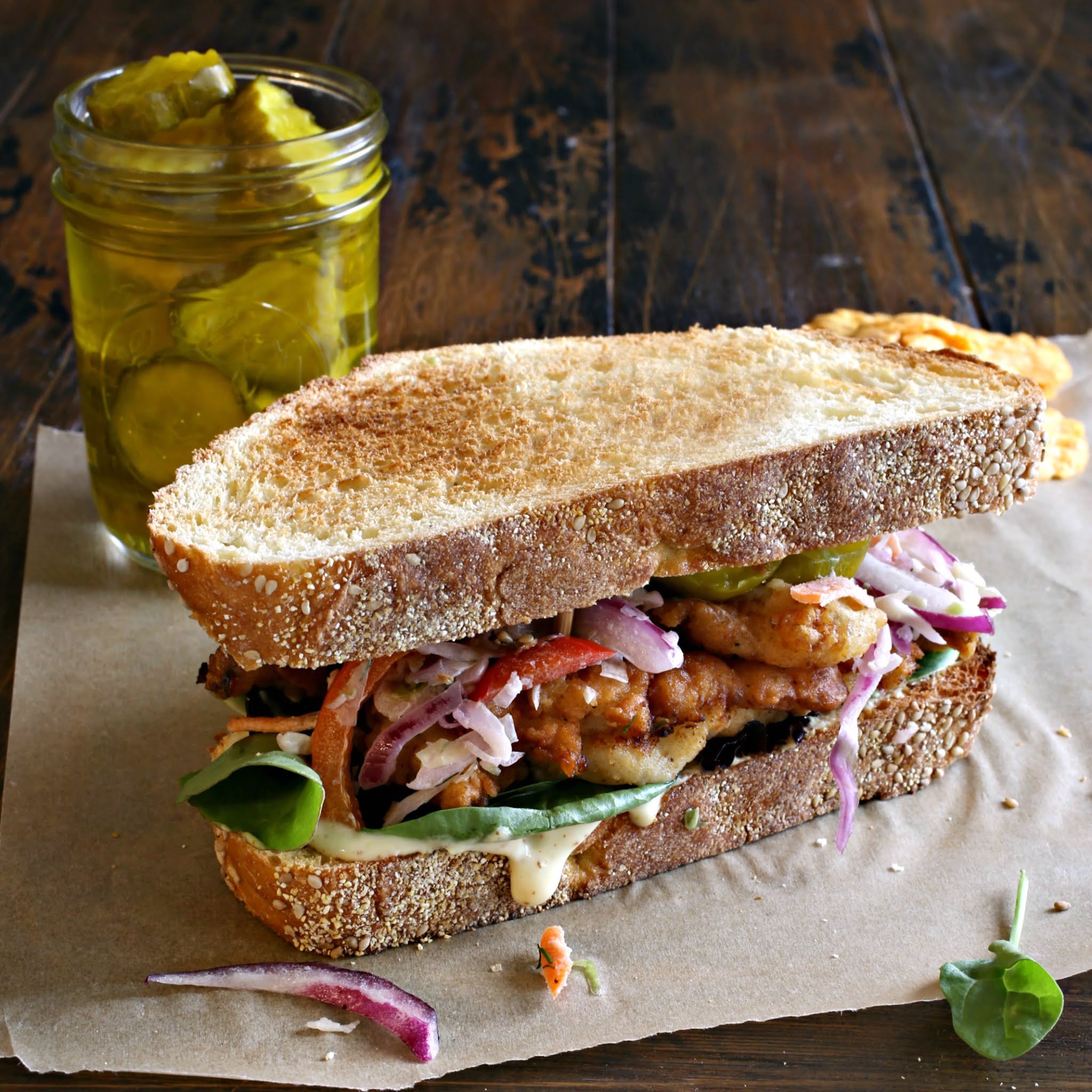 Recipe for chicken, marinated in buttermilk, coated, fried and served on toasted bread.