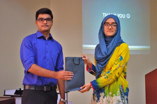 Syed Faizan Ali giving gifts to the winner of the Q/A Session