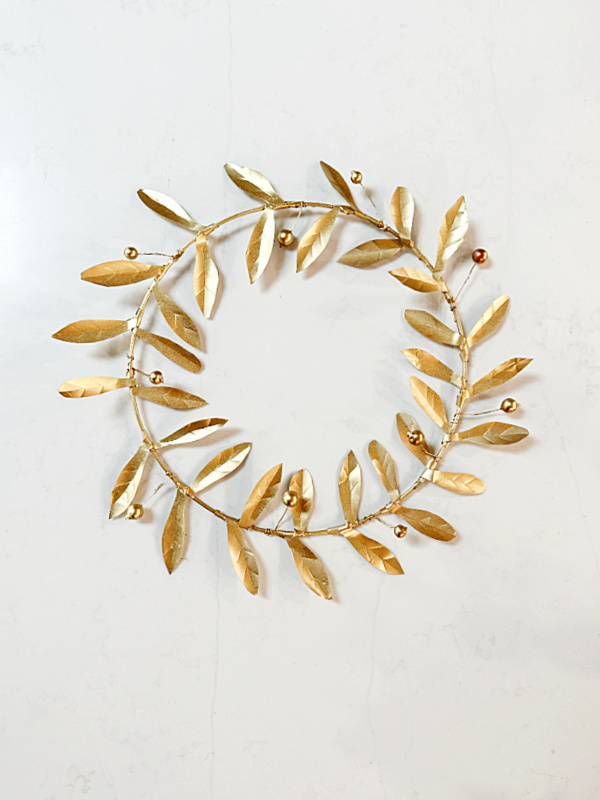 gold metal wreath with berries