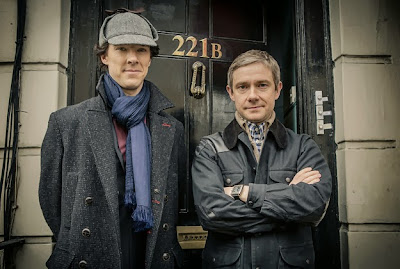 Benedict Cumberbatch and Martin Freeman as Sherlock Holmes wearing deerstalker and Dr John Watson outside 221 B Baker Street in BBC Sherlock Season 3