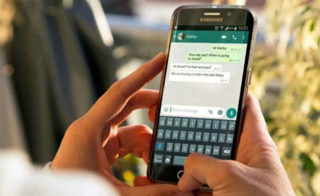 Alt: = "Hands typing message on WhatsApp Chat on mobile phone"