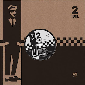 The 7" single sleeve and paper label feature checkerboards, a stylized illustration of Peter Tosh as a rude boy, and the 2 Tone Records logo.