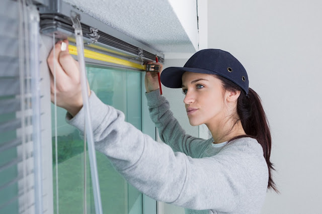 woman measuring a window