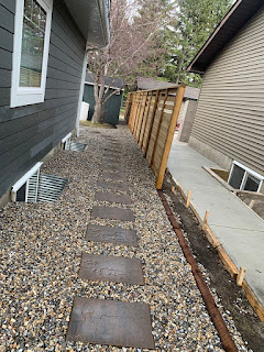 side yard stepping stones inside washed landscaping rocks