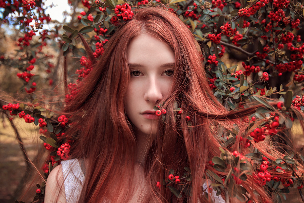 portrait of a beautiful young woman with bright red hair