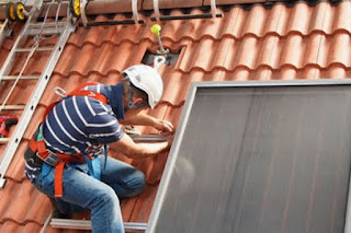 installing solar water heating modules on a roof