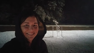 A selfie of Haley McAndrews in the dark, during a first dusting of snow for the winter.