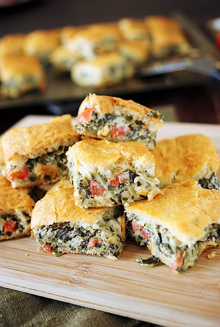 s favorite dip is baked between flaky layers of crescent rolls to create easy to serve Spinach Dip Crescent Bites