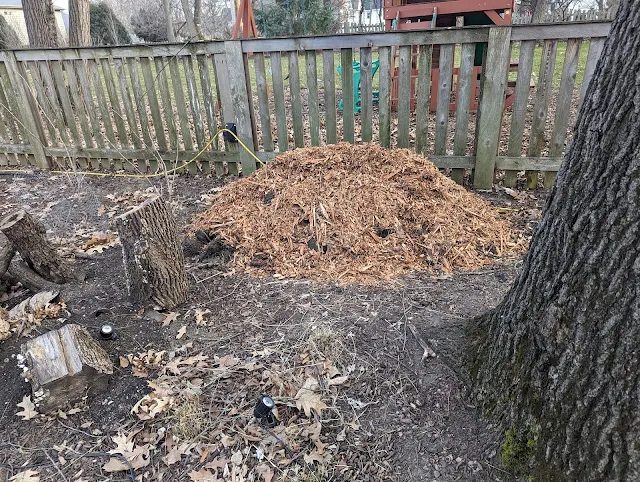 Covering Pile of Soil and Grass with Wood Chips to Kill The Grass