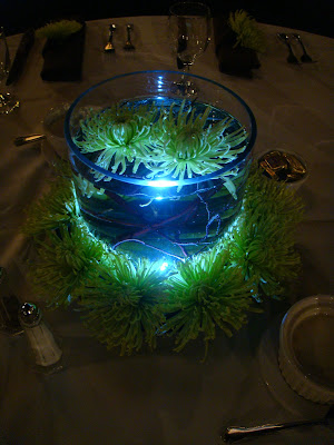 Several different centerpiece designs all incorporating green flowers