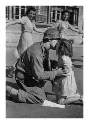 American soldier kissing a young girl in France after liberation, 1944