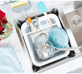 a full dish rack sitting in the sink