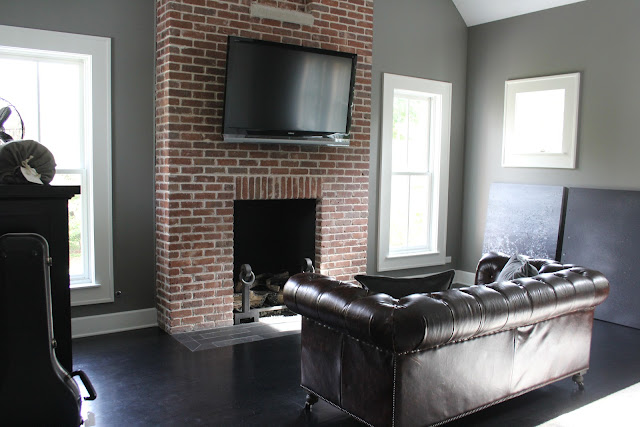 Exposed brick fireplace in modern farmhouse master bedroom on Hello Lovely Studio