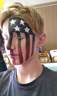 A young man with an American Flag painted on his face