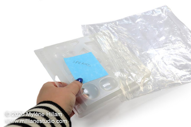 Inserting a sprayed plastic mould into a ziplock bag