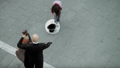 Girl gave coin to the musician