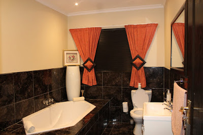 Family Bathroom and toilet with bath, shower basin and toilet, tiled to the ceiling