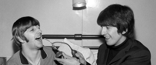 El baterista Ringo Starr recibe la visita de su compañero Beatle George Harrison mientras se recupera de una operación para extirparle las amígdalas en Londres, el 5 de diciembre de 1964