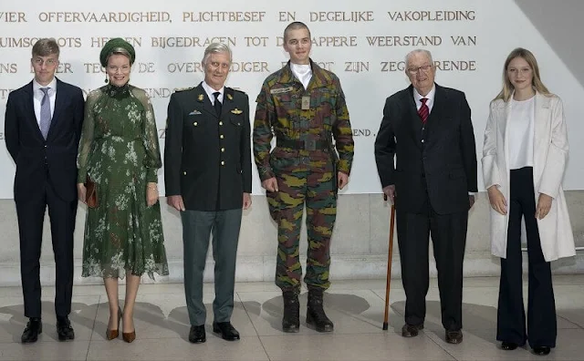 Queen Mathilde wore a green floral print tulle dress and green coat by Natan. Princess Eleonore wore a white cashmere coat