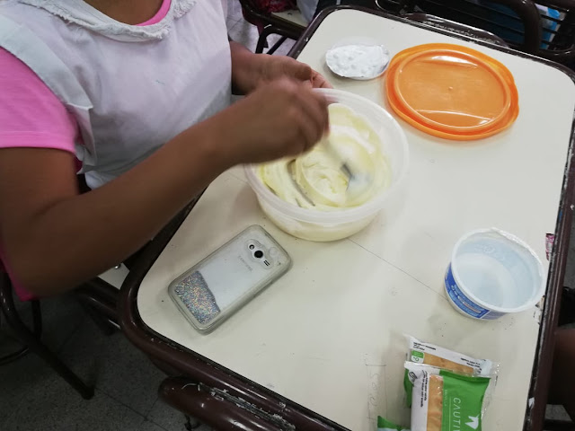 se observa una alumna mezclando en el bol los ingredientes para hacer la crema